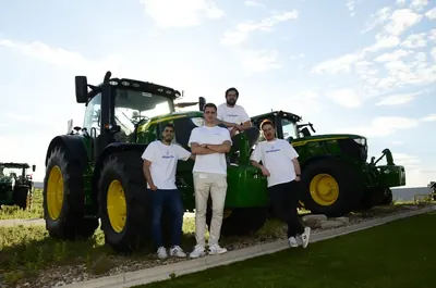 Members of the Abastores team next to a tractor in the field